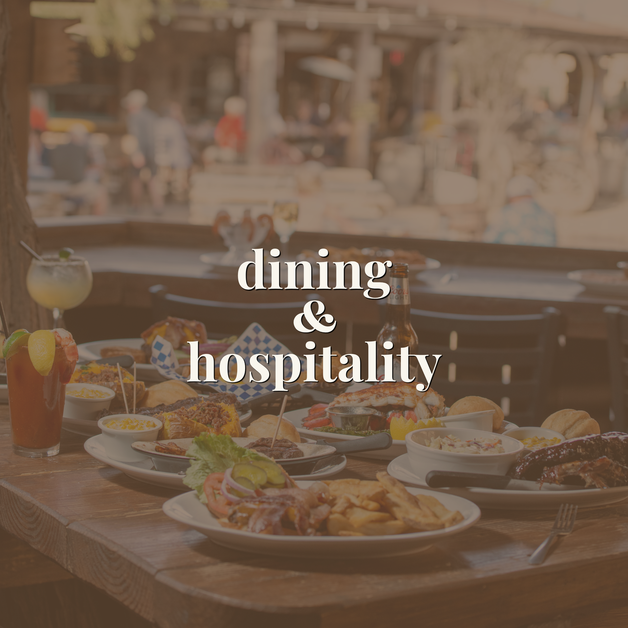 Table of restaurant dishes and drinks on an outdoor patio — link to the dining and hospitality portfolio